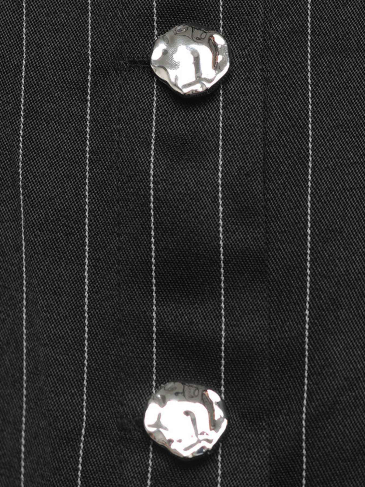 Close-up of a black pinstriped shirt or jacket fabric with two prominent silver textured buttons.