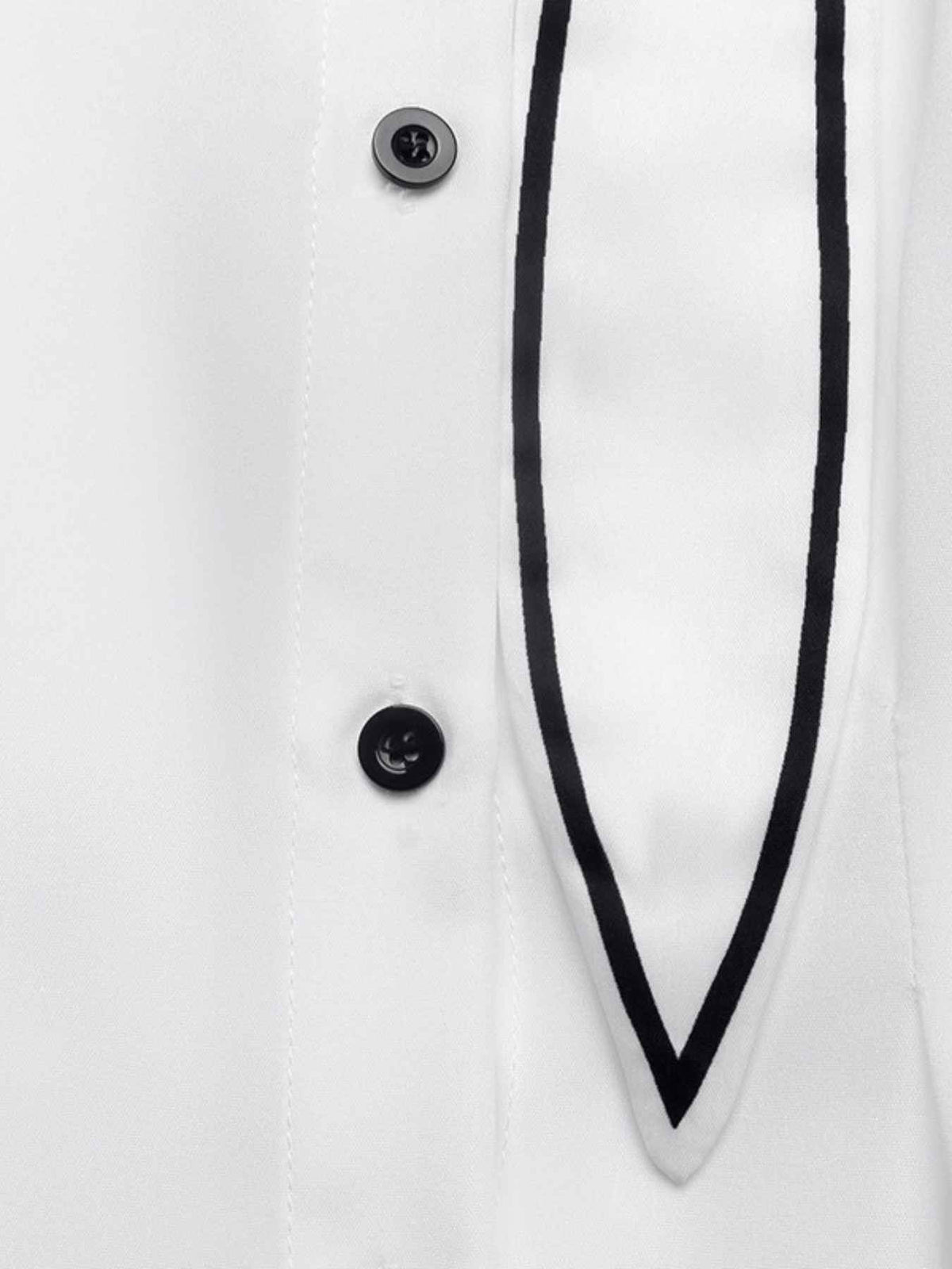 Close-up of a white shirt front with two black buttons and a black piping trim along the placket.