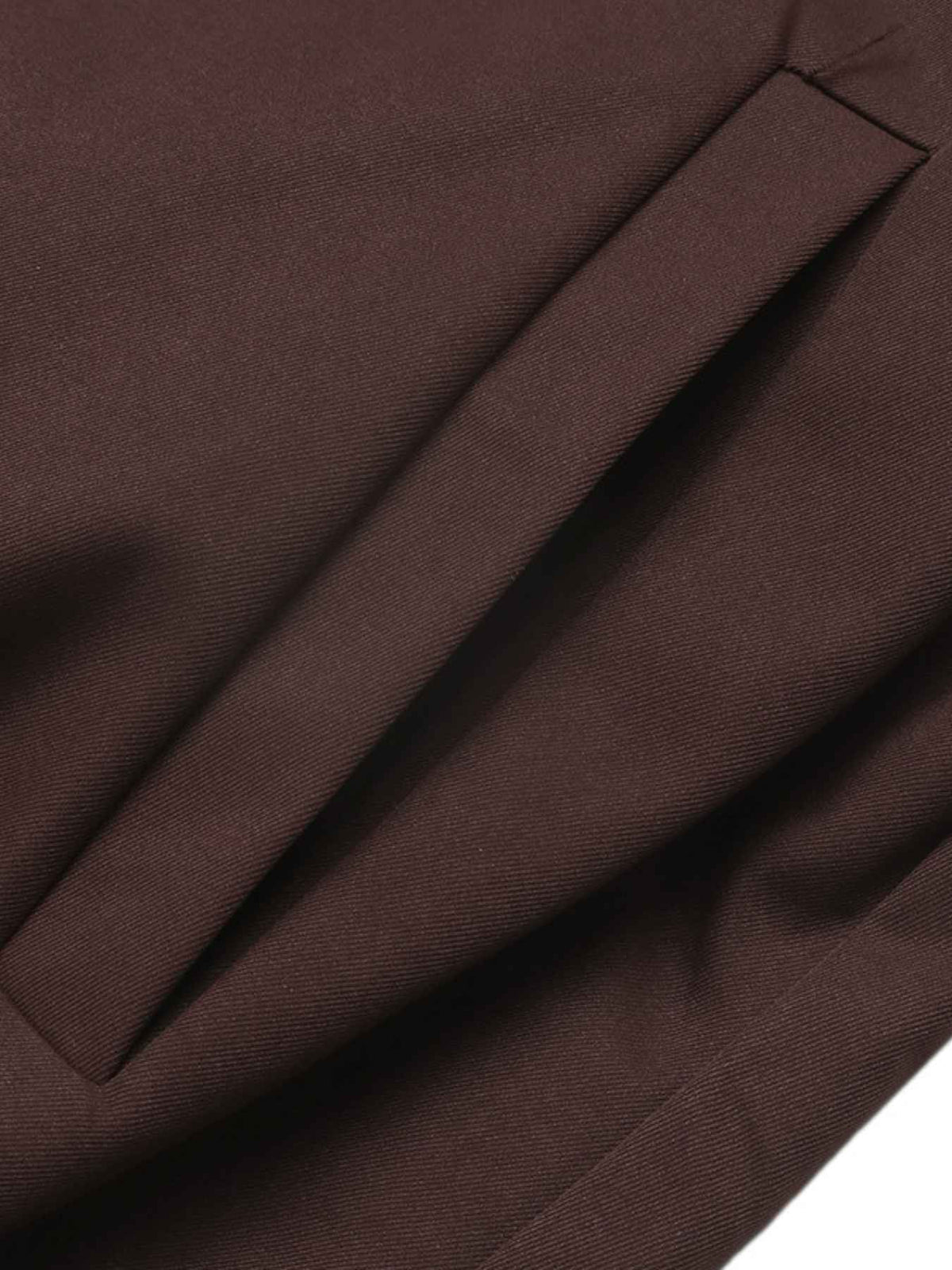 Close-up of dark brown fabric with a diagonal pleat or fold detail, showing the material texture and color.
