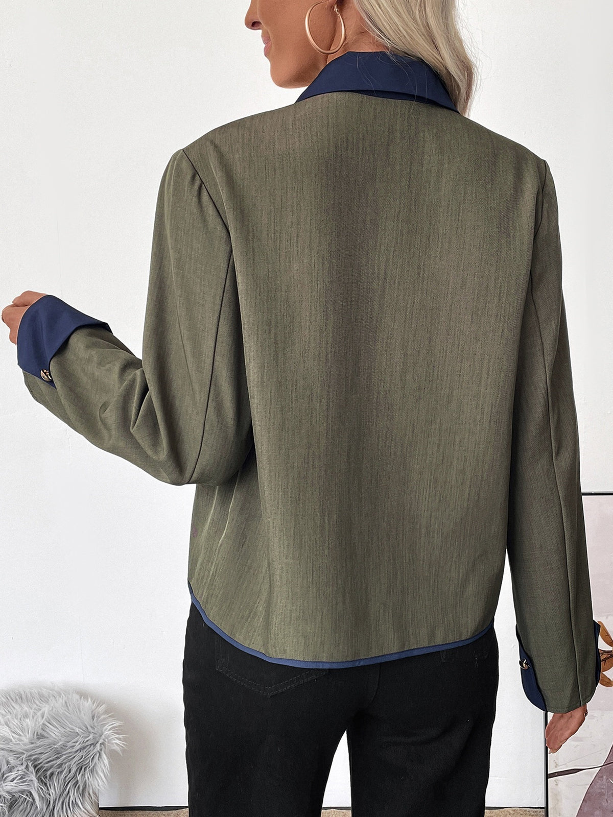 Person wearing a green jacket with a white background