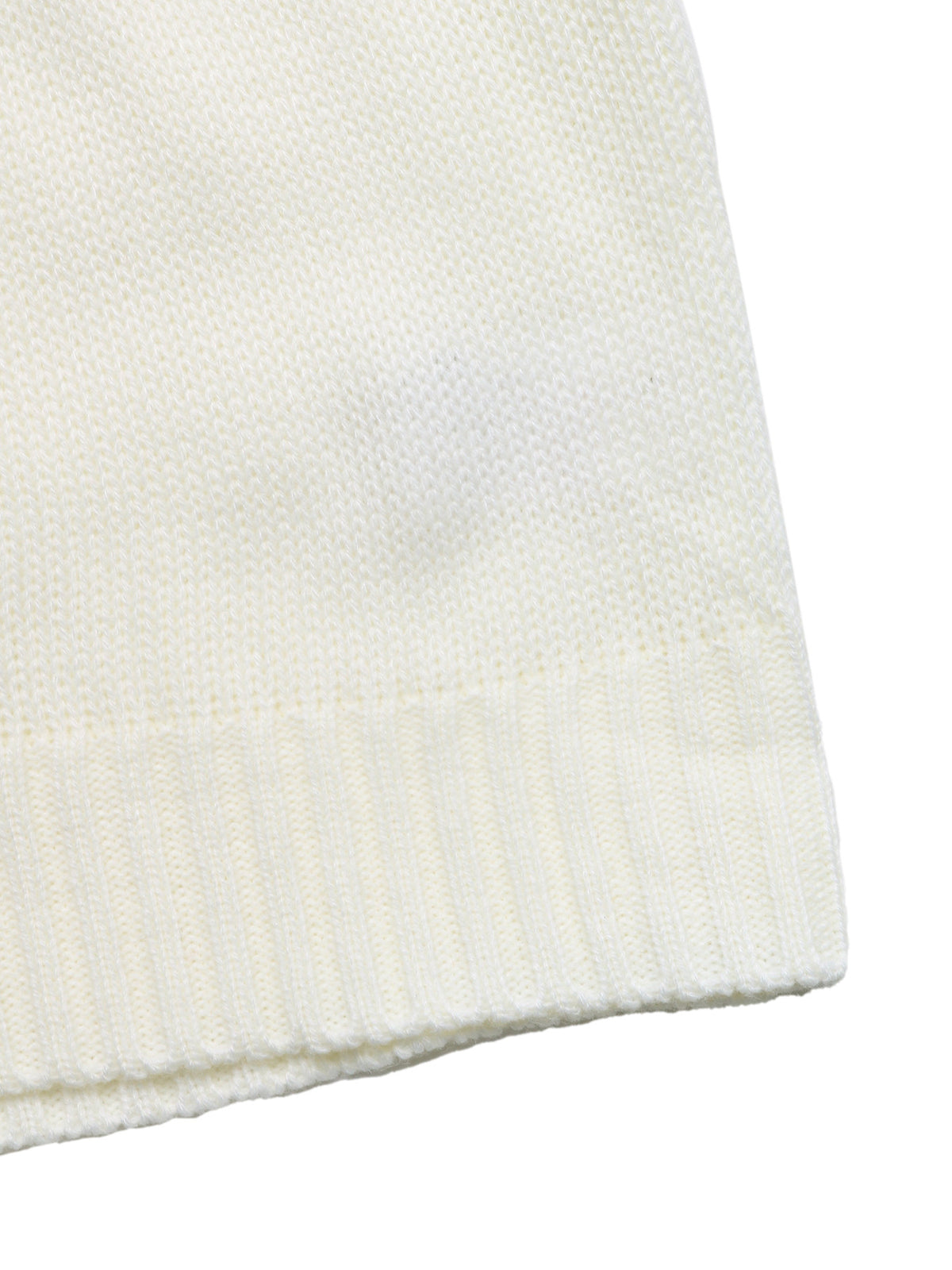 Close-up of a cream-colored knit fabric with a ribbed cuff on a white background.