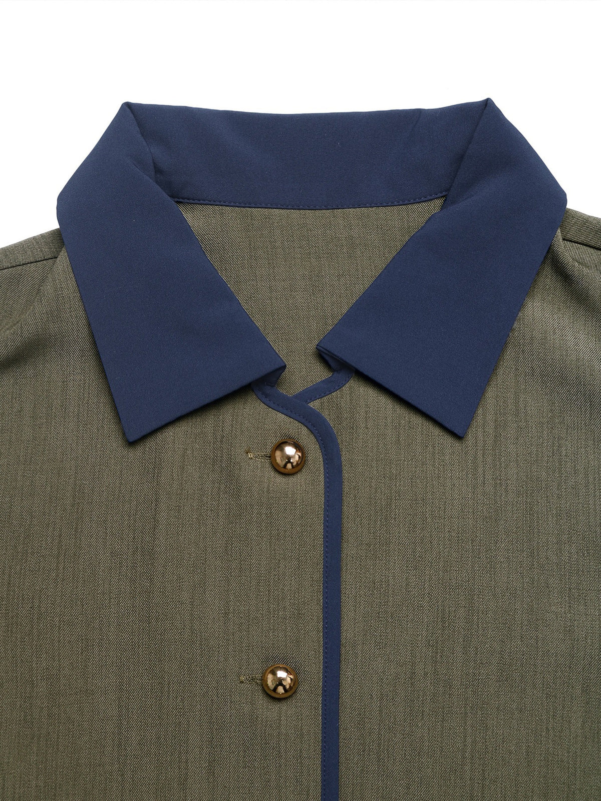 Close-up of a green shirt with a blue collar and gold buttons on a white background