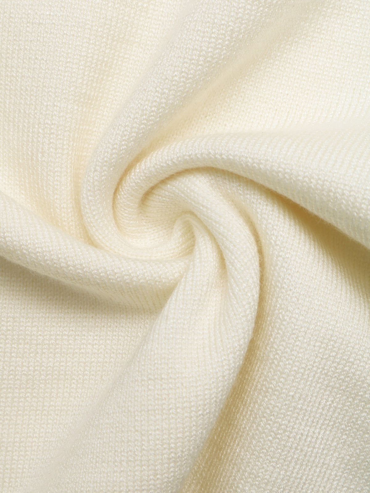 A close-up of cream-colored textured knit fabric, swirled in a spiral pattern to show its fine ribbed weave.