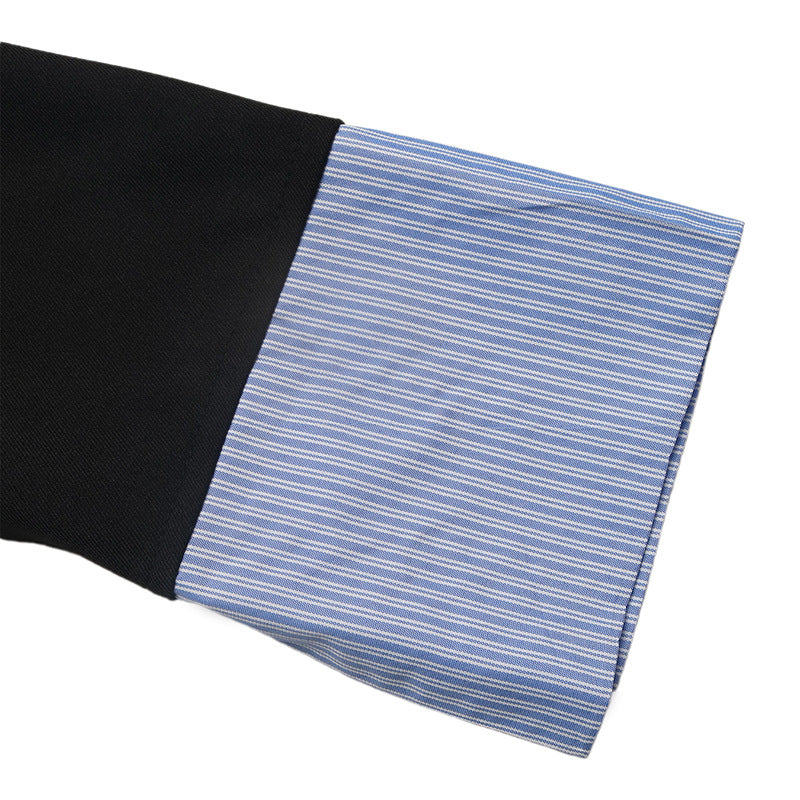 Blue and white pinstripe shirt cuff on the black blazer sleeve