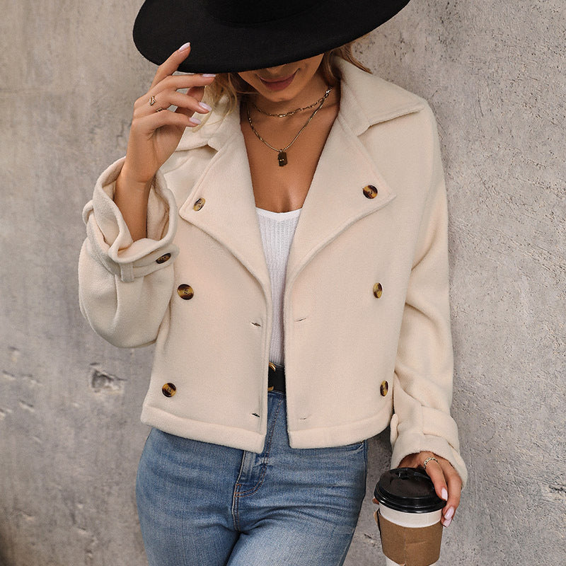 Women's cream cropped double breasted jacket with notch collar, styled with jeans and a black hat
