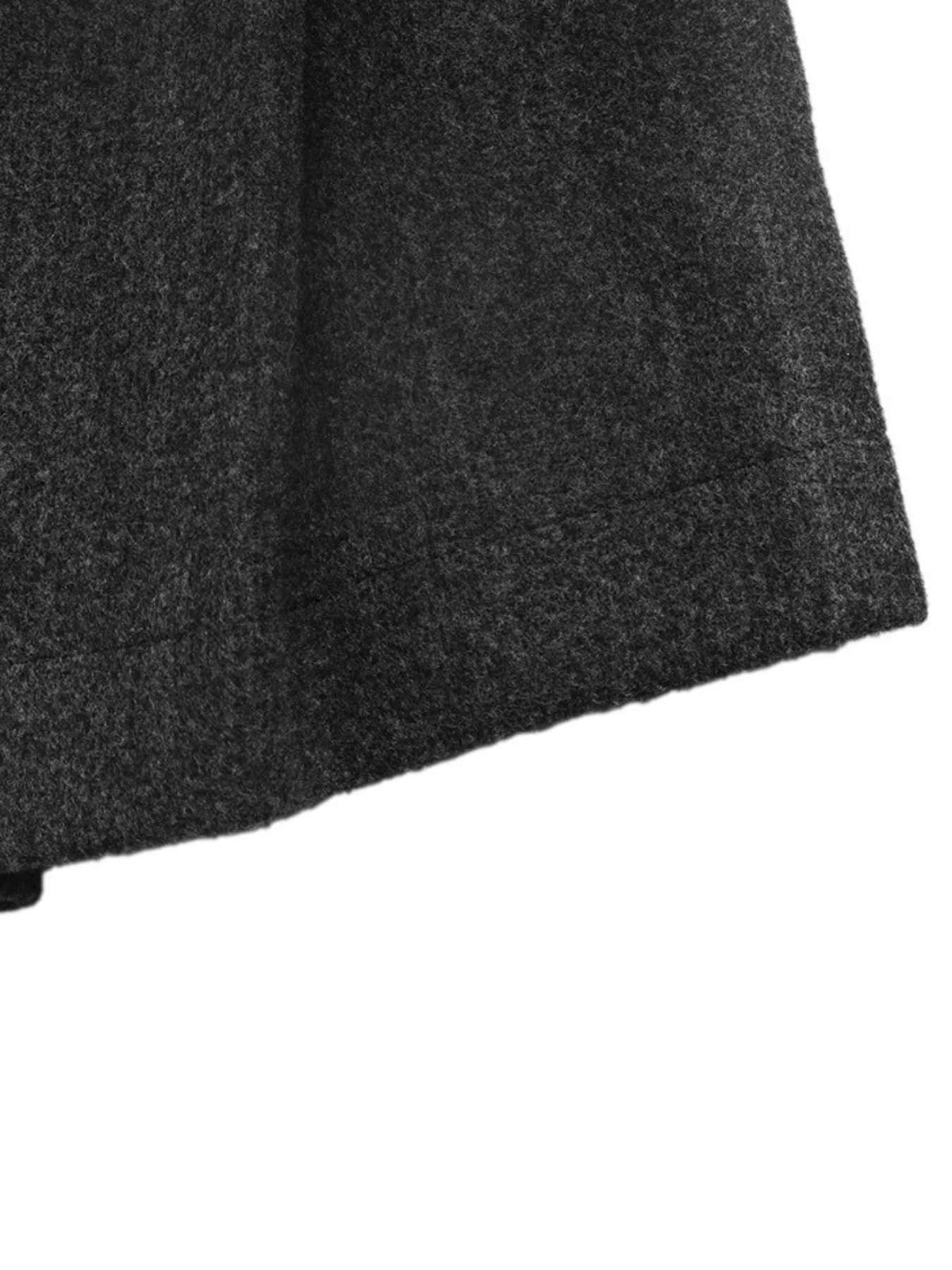 Close-up of a dark charcoal gray textured fabric, showing a folded hem or edge against a plain white background.