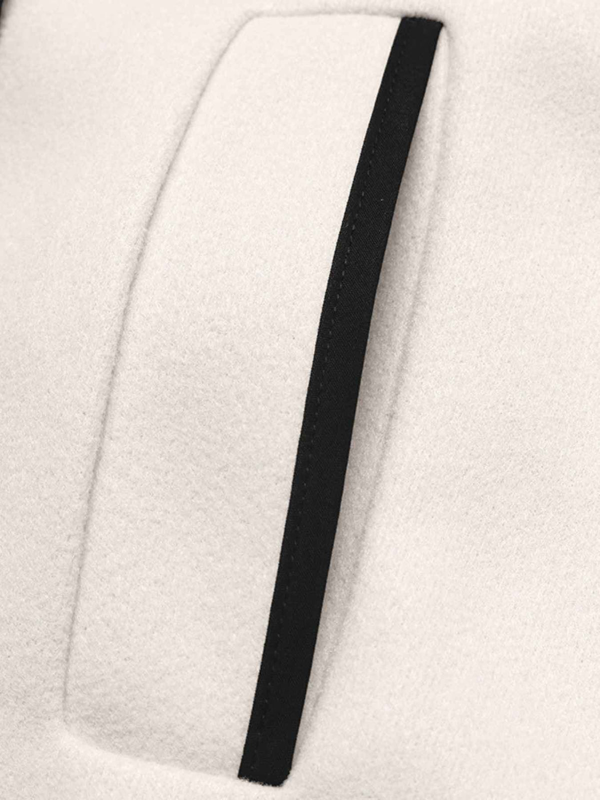 Close-up of a black strip on a white fabric background