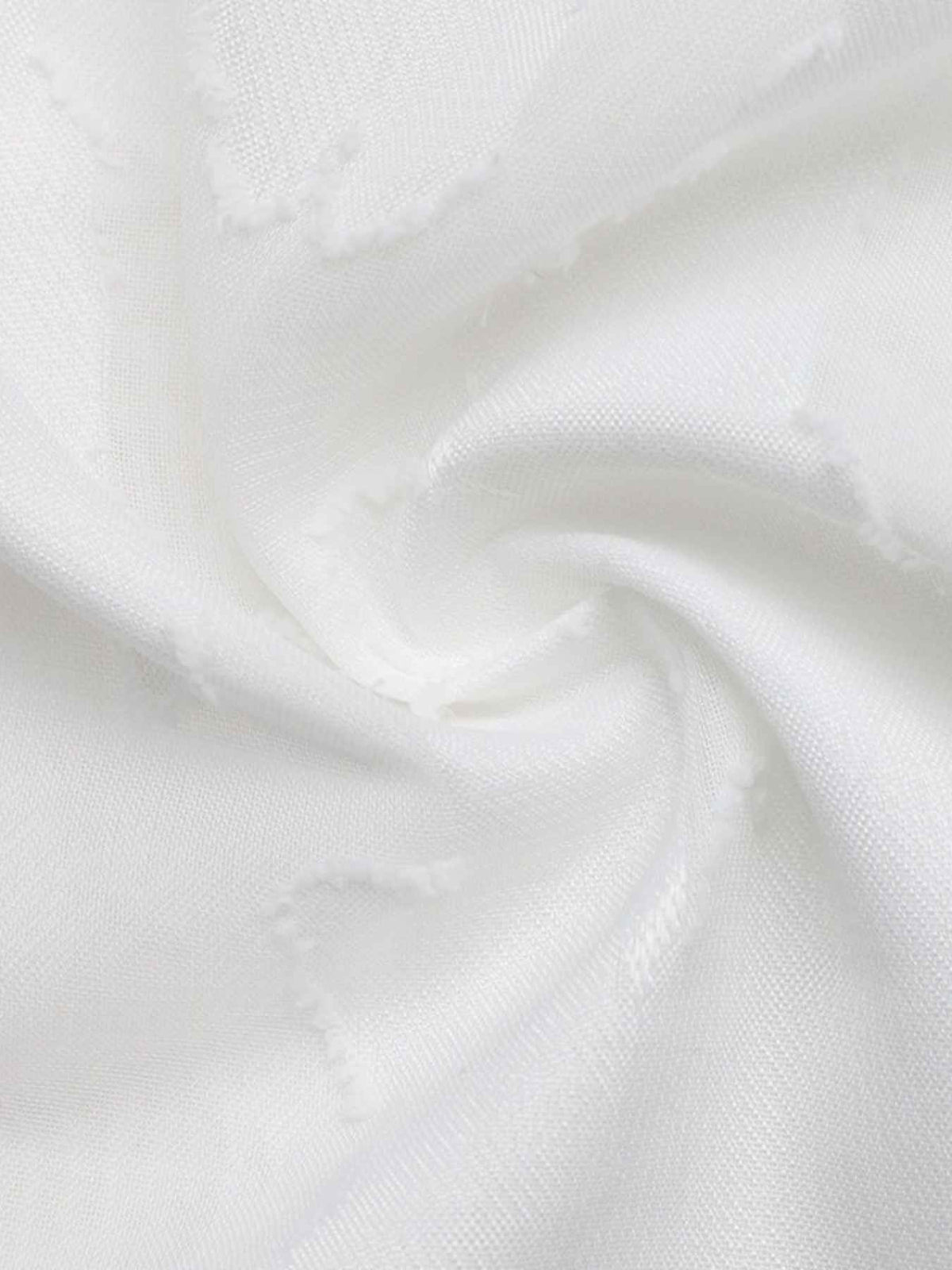 A close-up of white textured fabric with a soft, slightly sheer weave and gentle folds.