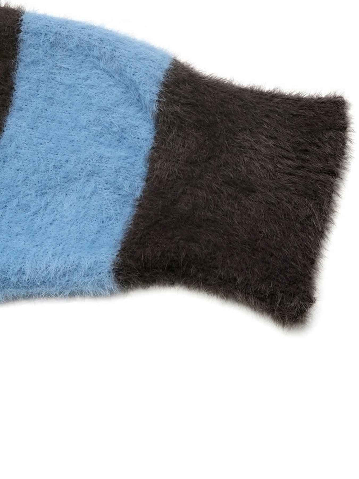 A close-up of a fuzzy knit or faux-fur sleeve showing two color blocks: a light sky blue section and a dark brown section, on a plain white background.