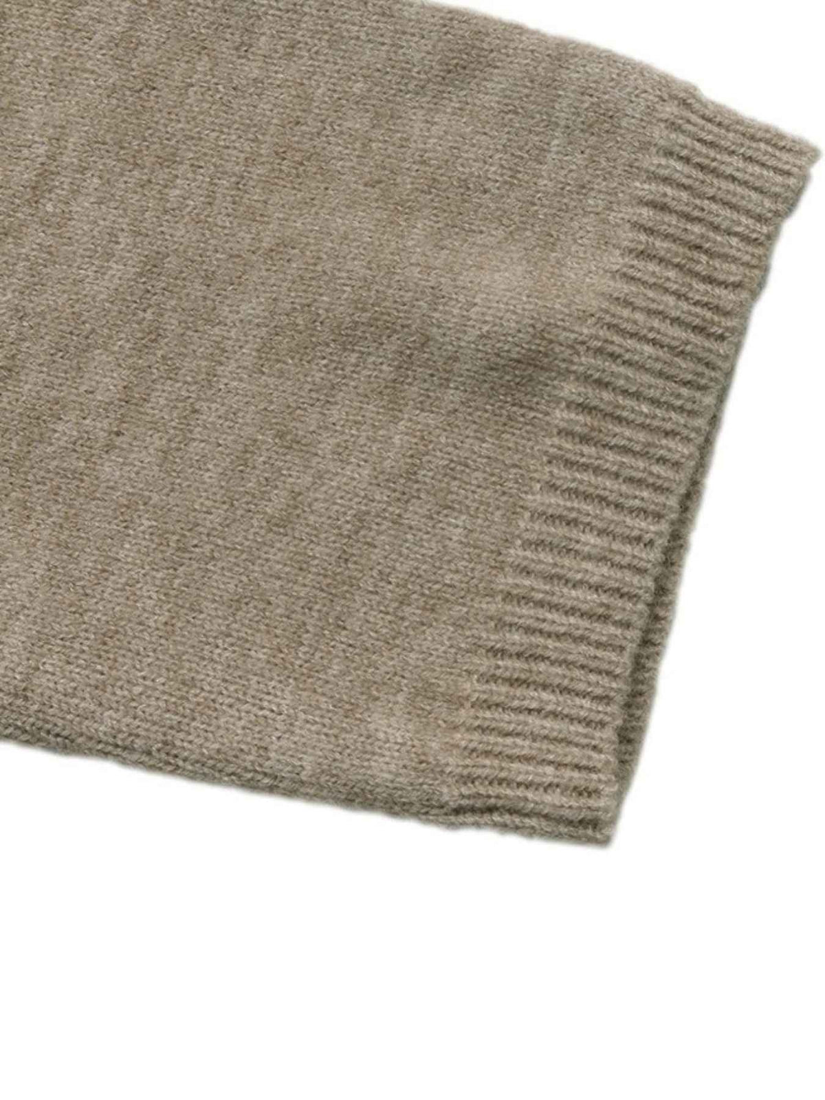 Close-up of a ribbed knit sleeve or cuff in a warm taupe-beige color, showing the texture and stitching detail against a plain white background.