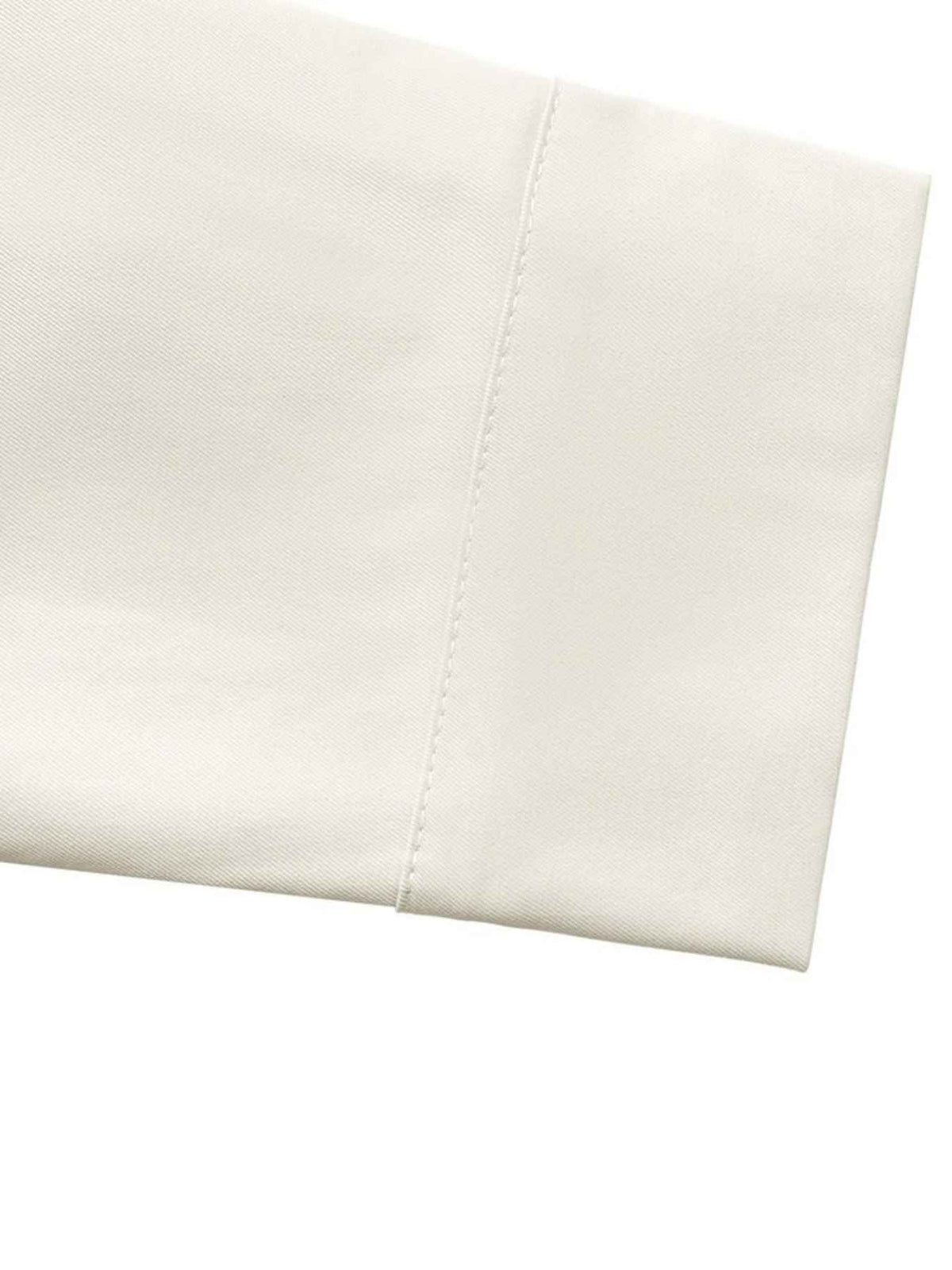 A close-up of a folded off-white or cream fabric with a clean stitched edge, shown against a plain white background.