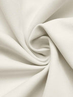 A close-up of off-white fabric with a subtle ribbed texture, artistically draped in a spiral pattern.