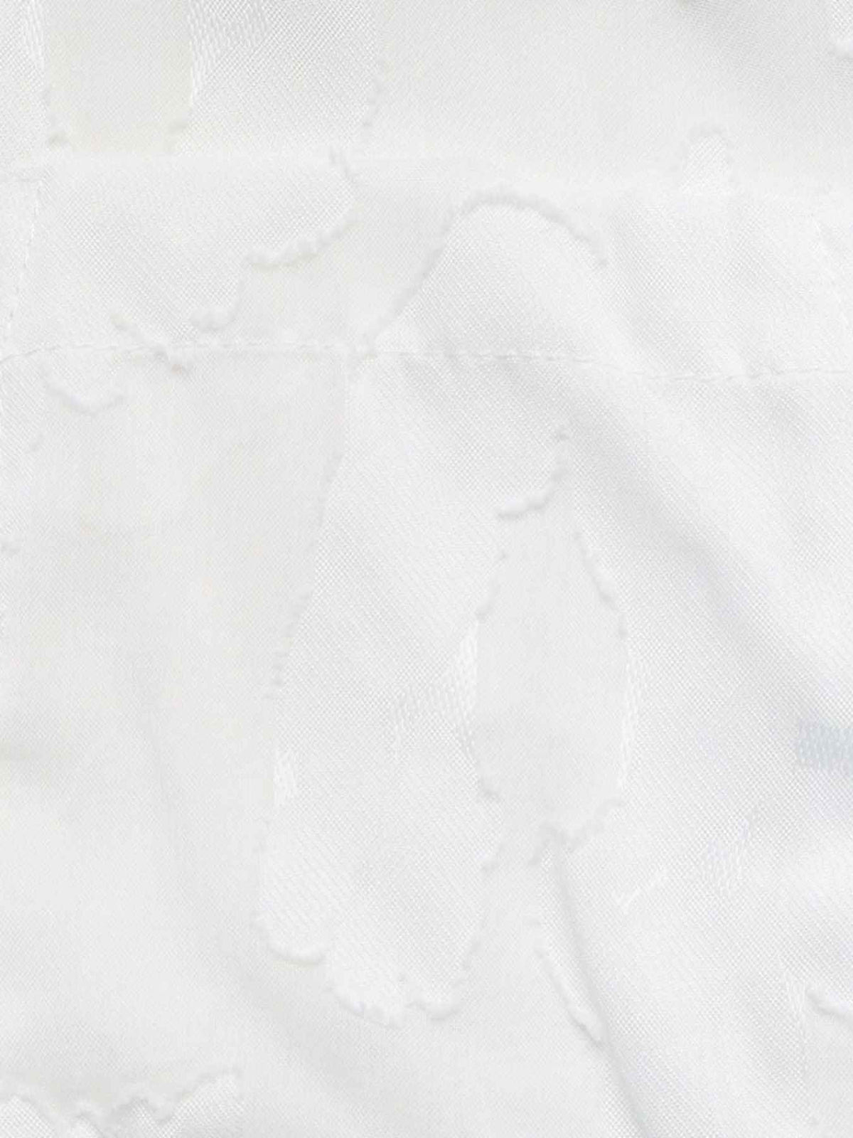 A close-up of white fabric with a subtle tonal jacquard or woven pattern.