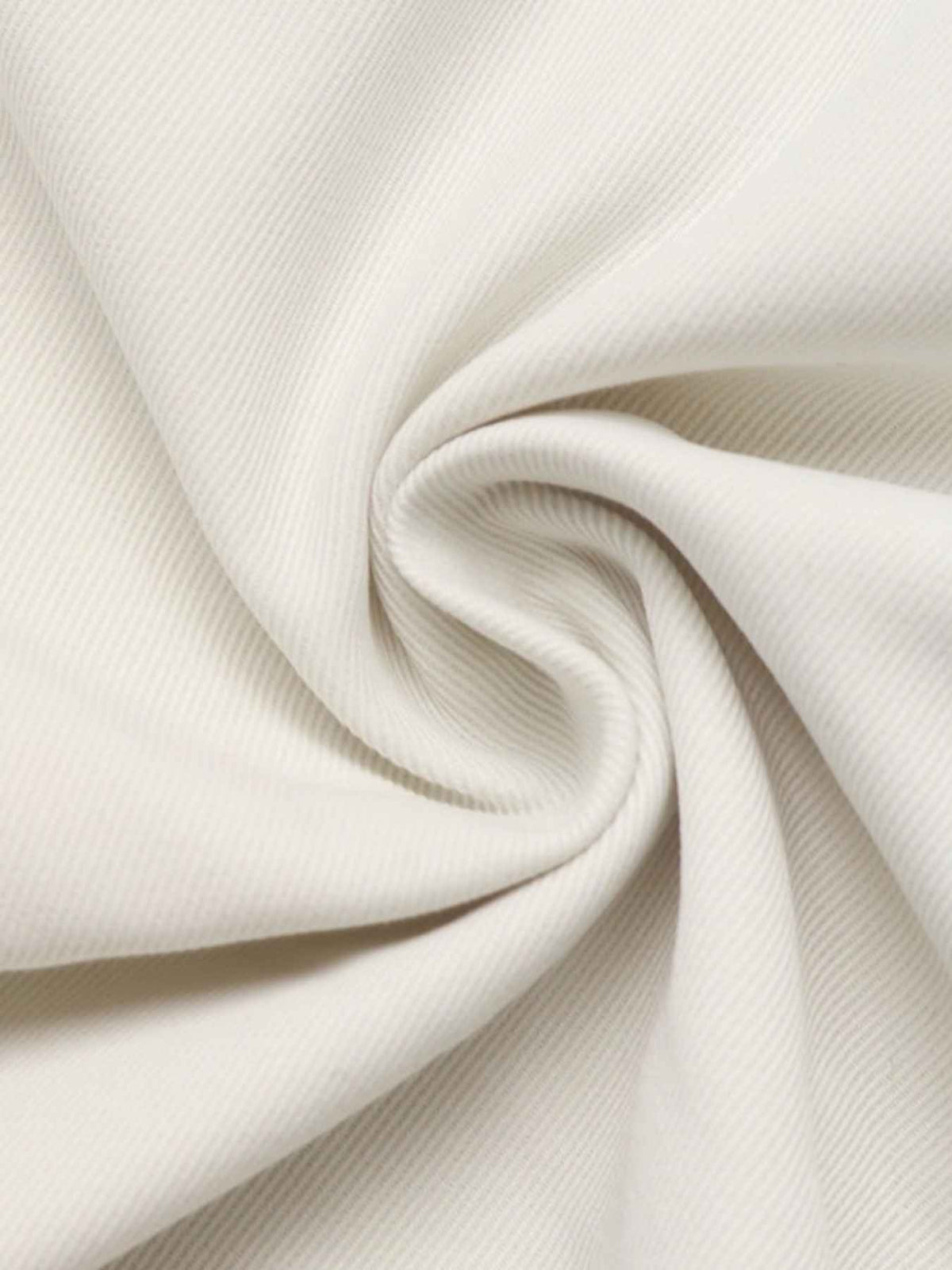 A close-up of off-white fabric with a subtle ribbed texture, artistically swirled and draped to show its soft folds and texture.