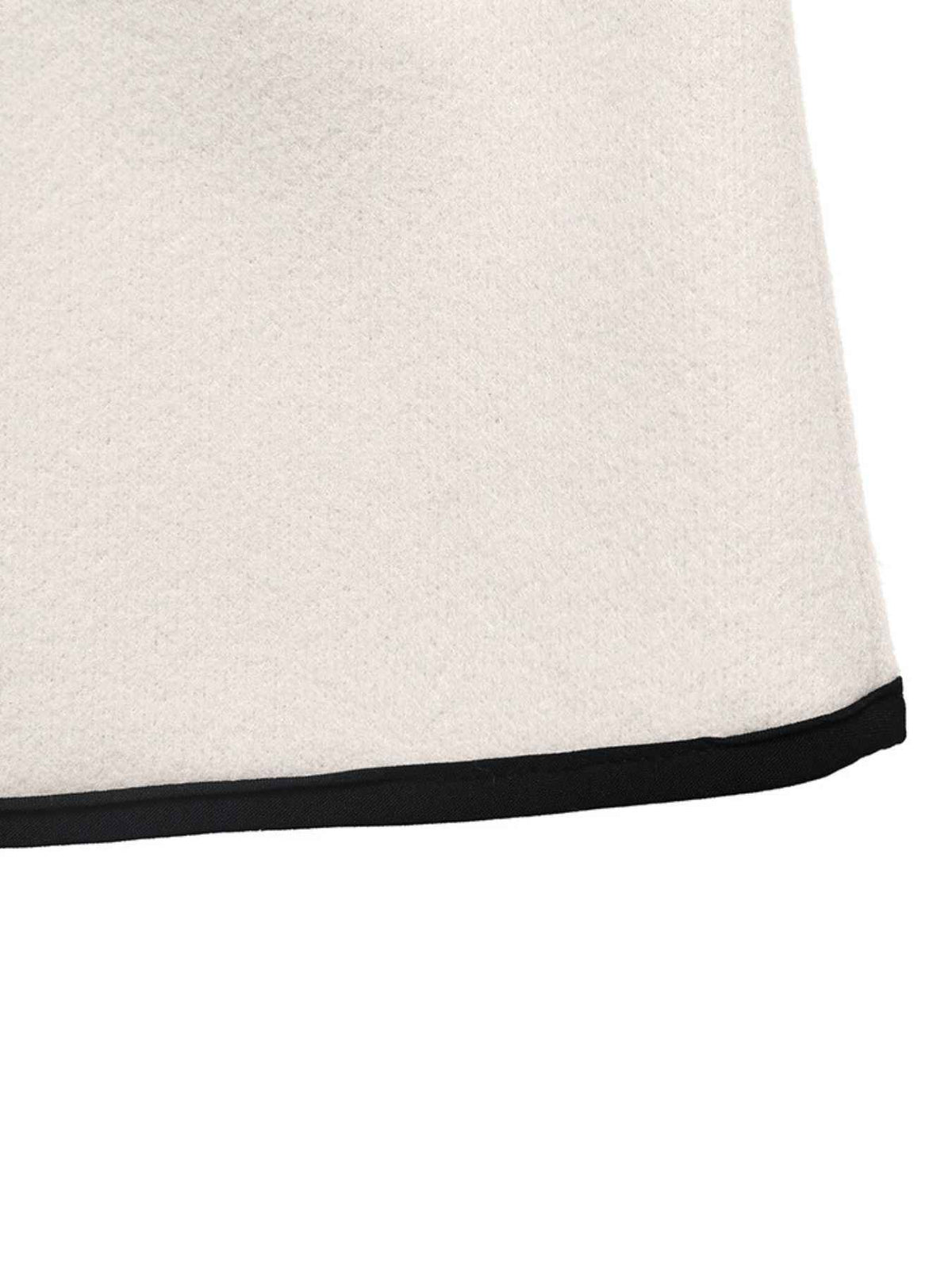 Close-up of a light cream or off-white textile surface with a thin black trim along the bottom edge, shown against a white background.
