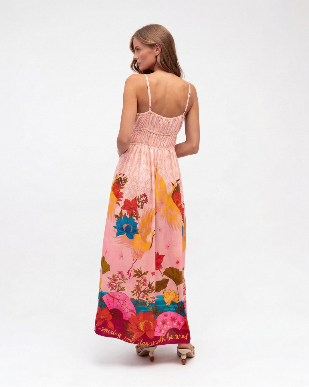 Woman wearing a colorful floral dress on a white background