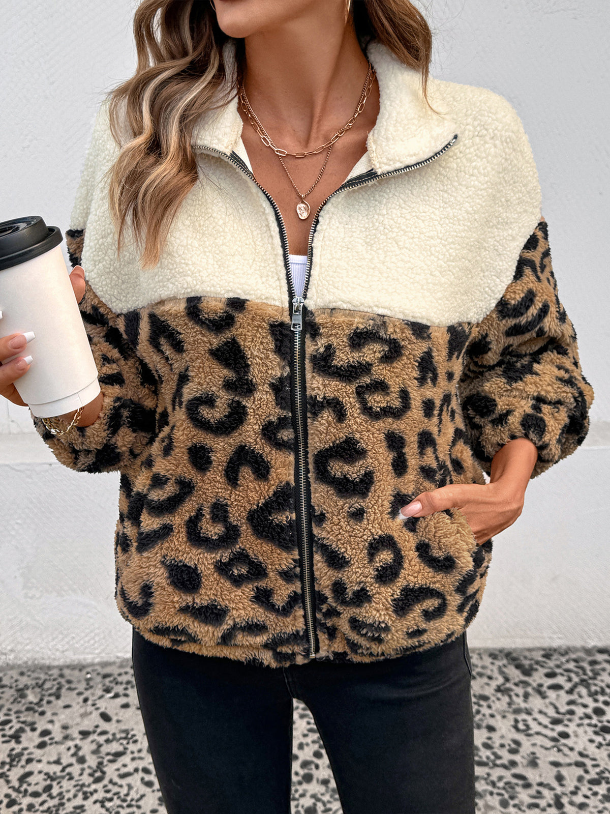 Close up of the leopard print teddy jacket with a hand in the side pocket