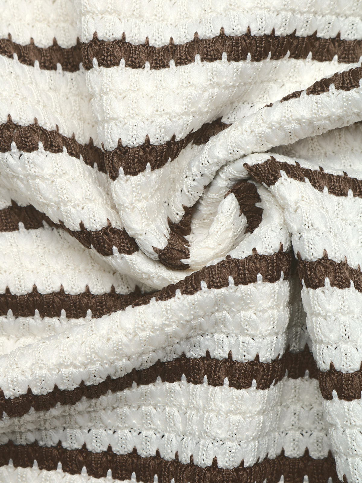 A close-up of a textured knit fabric with horizontal stripes in dark brown and off-white, styled with a central swirl.