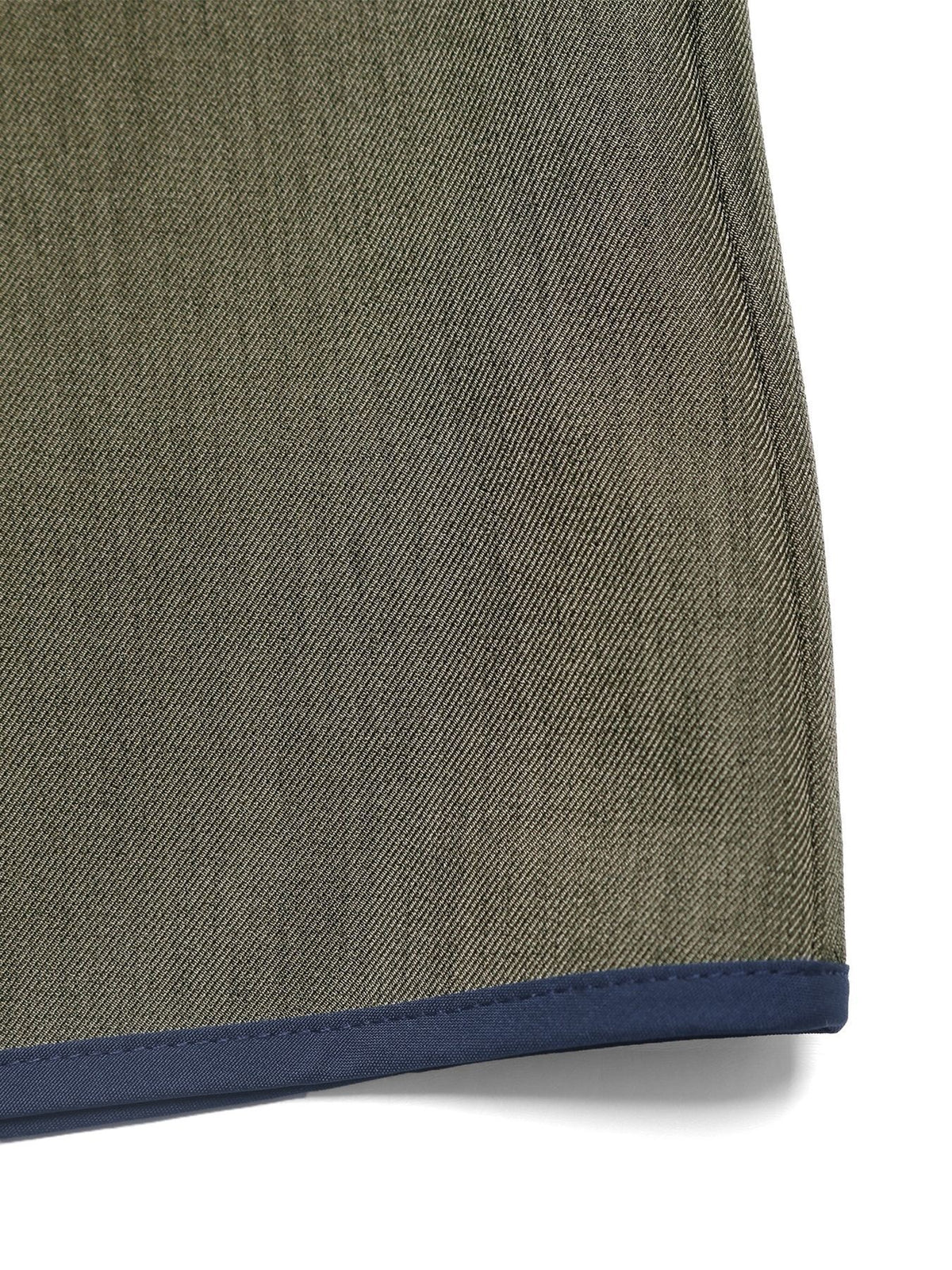 Close-up of a green fabric with a blue edge on a white background