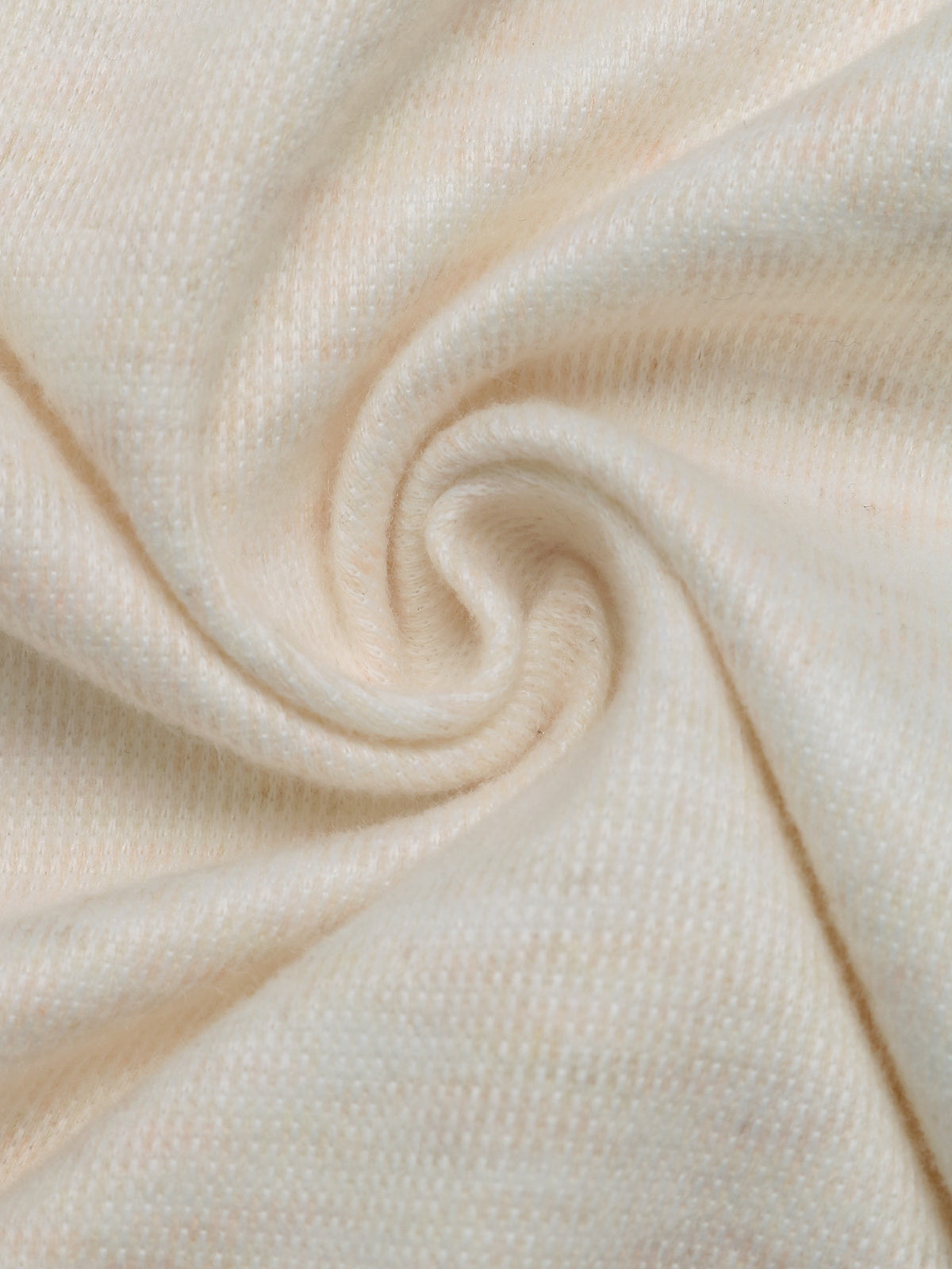 A close-up of a soft, textured cream-colored fabric swirled in a spiral pattern.