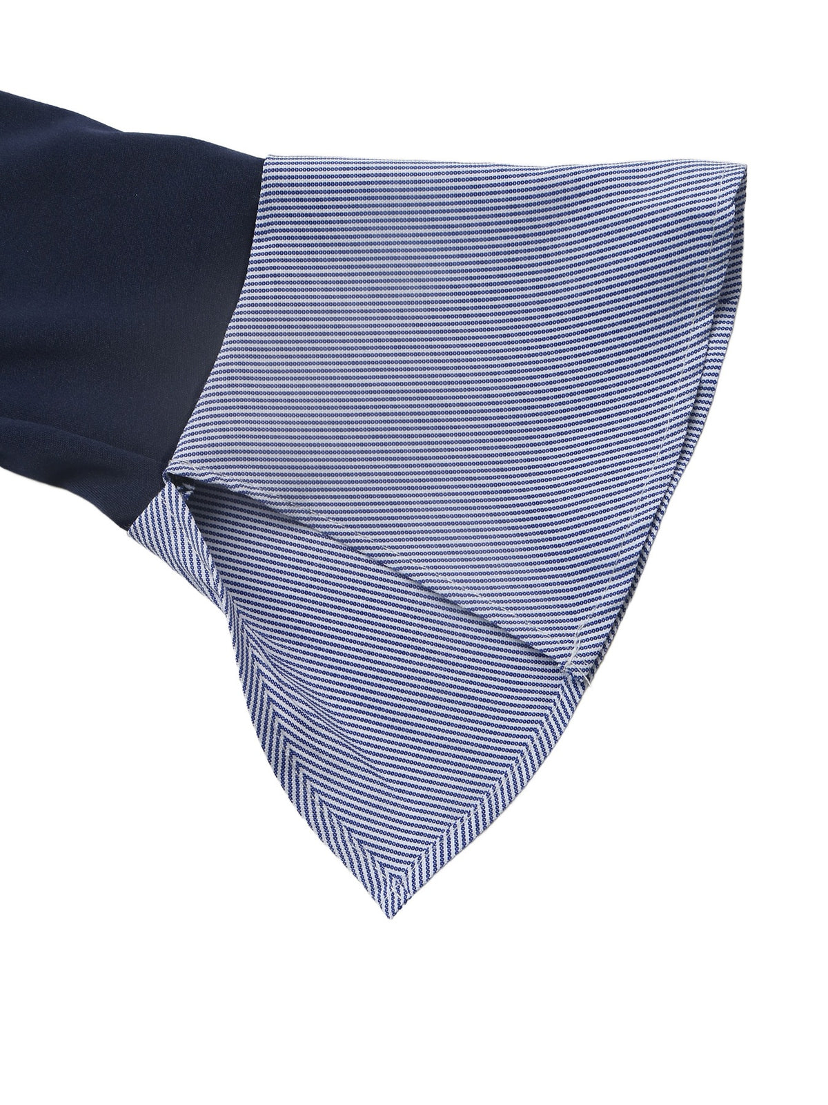 A close-up of a dress shirt cuff showing a solid navy blue sleeve and a blue and white striped button-down fabric cuff, set against a plain white background.