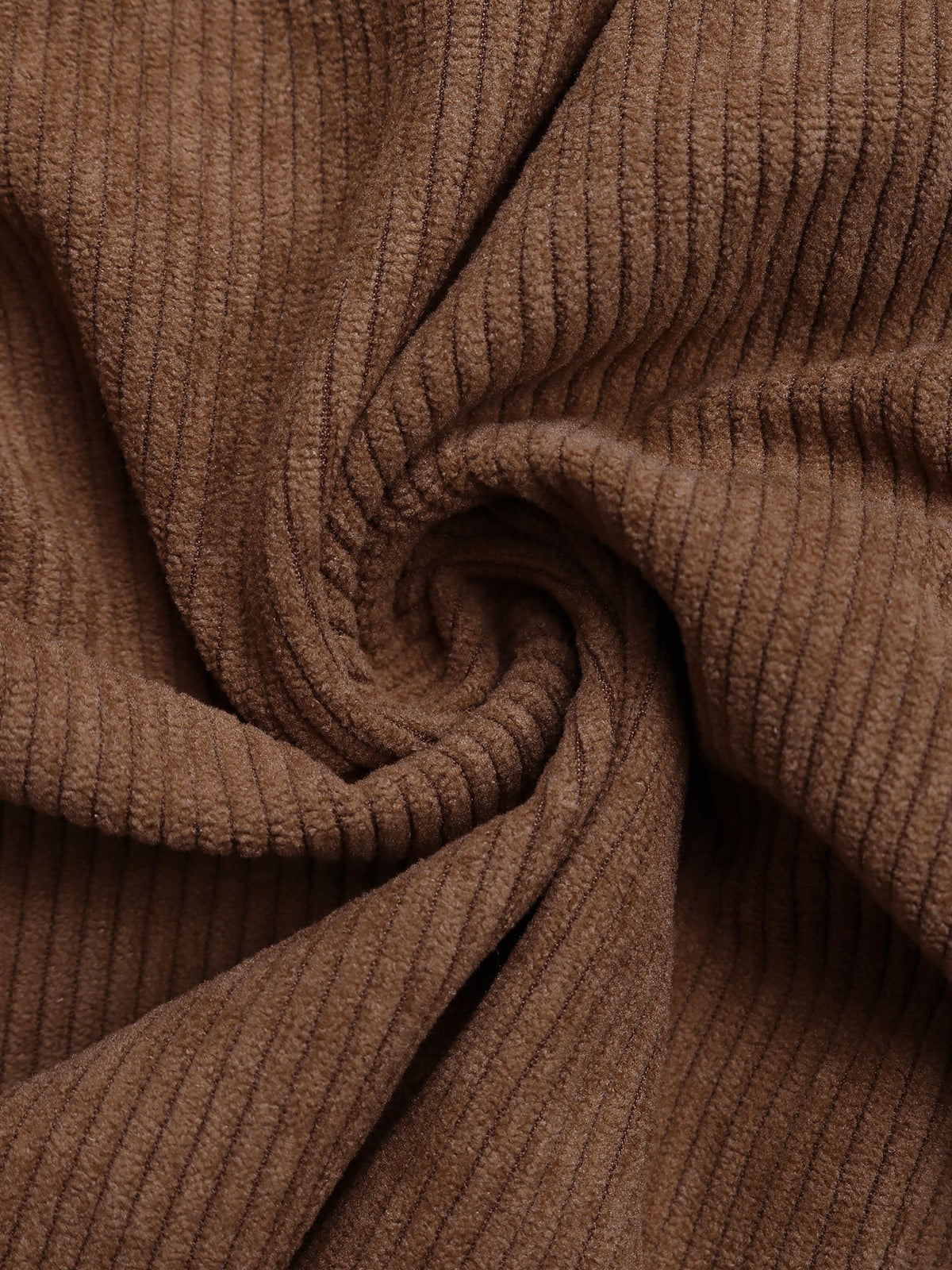 Close-up of brown ribbed fabric with a swirl pattern