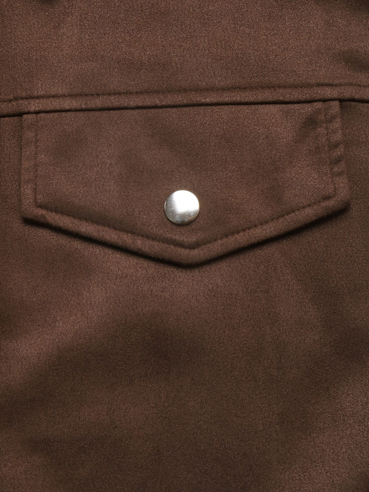 Close-up of a brown textured jacket or overshirt featuring a pointed flap pocket with a single silver metal snap button closure.