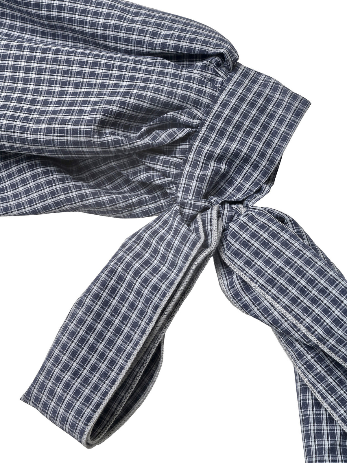 Close-up of a navy blue and white checkered fabric garment tied in a knot, showing the texture and pattern against a white background.