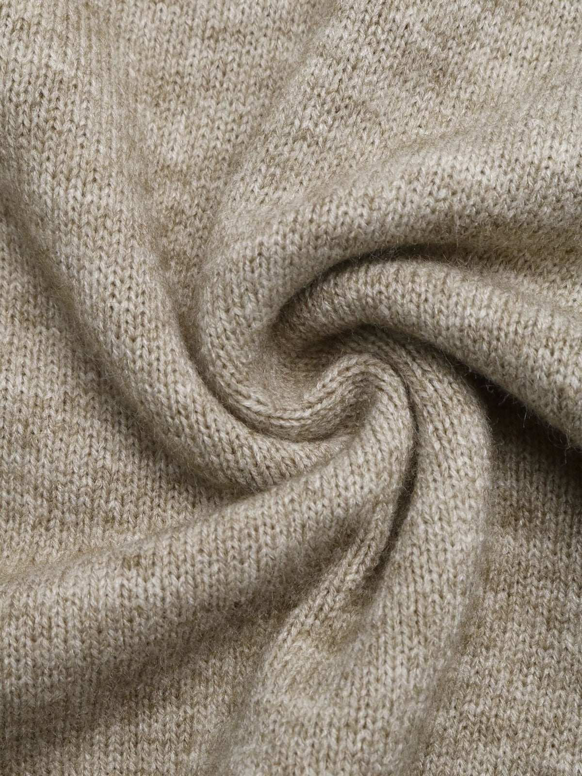 A close-up of a soft, knitted fabric in a warm light beige or oatmeal color, arranged in a spiral drape to show texture and flexibility.