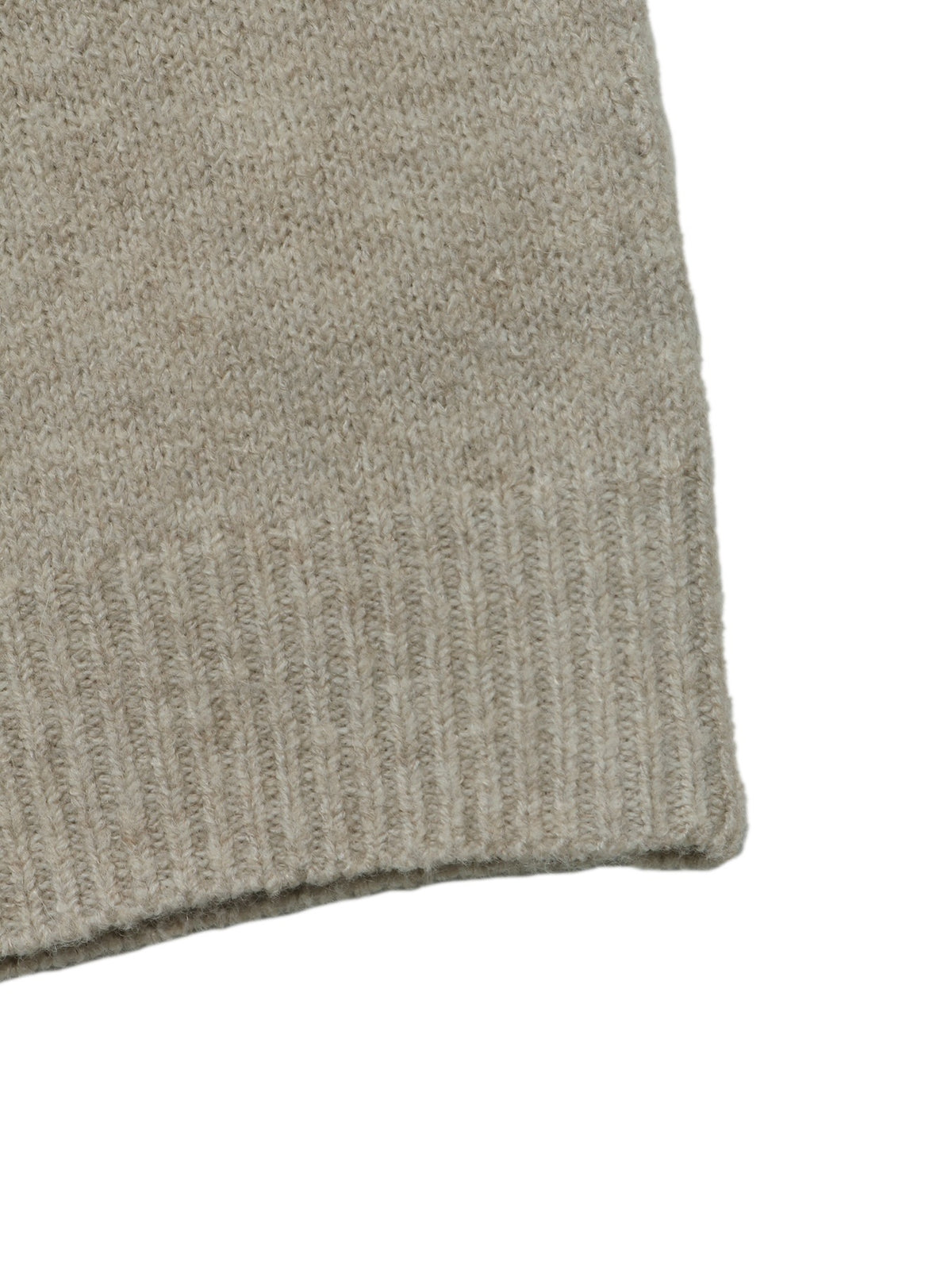 Close-up of a light taupe knit fabric with a ribbed cuff on a white background.