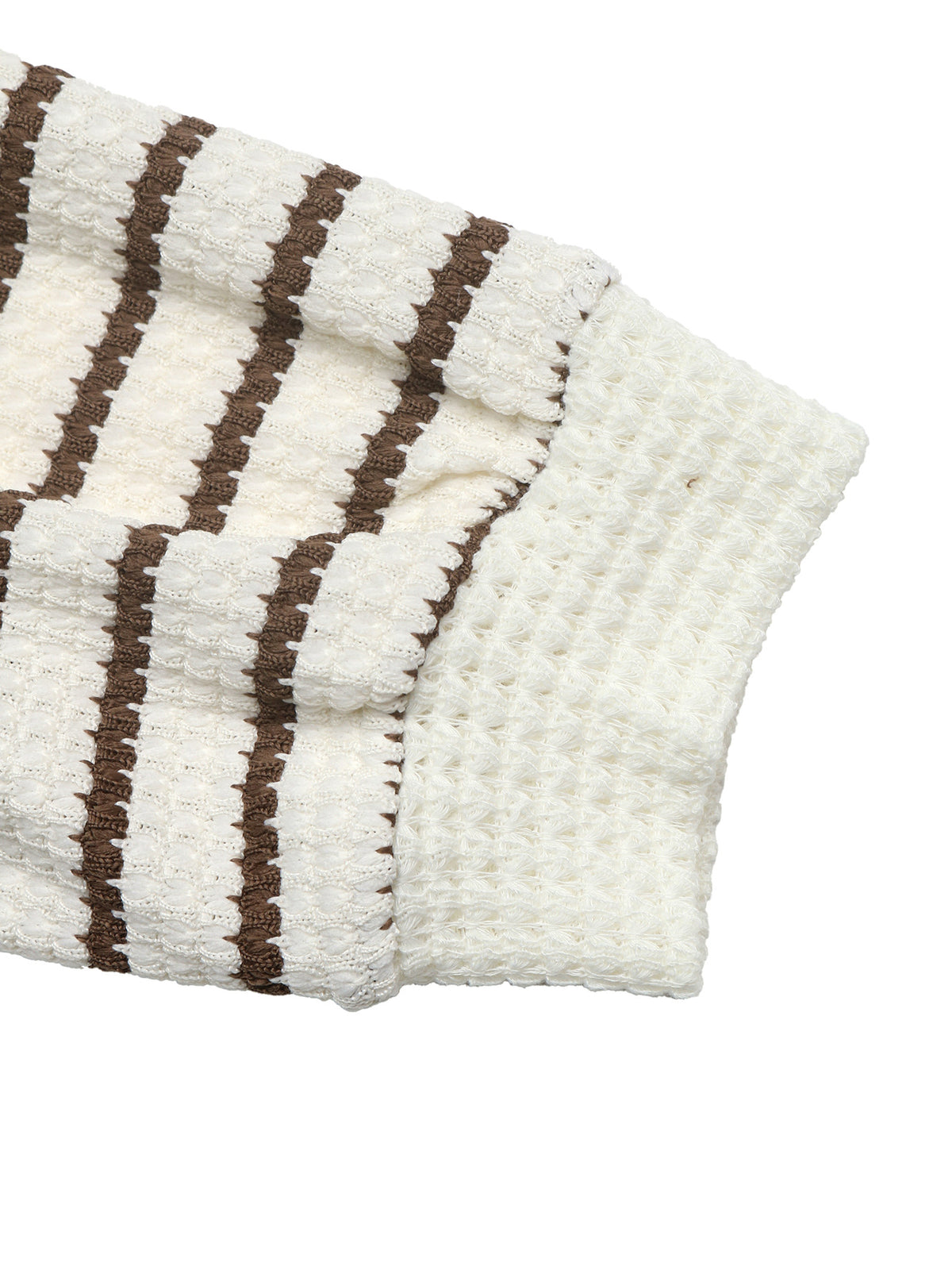 A close-up of a textured knit garment, showing a cream-colored waffle-knit body with vertical brown stripes and a matching ribbed waffle-knit cuff.