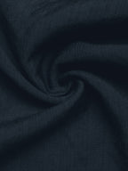 A close-up of dark navy blue textured fabric, swirled in the center to show its woven texture and soft drape.