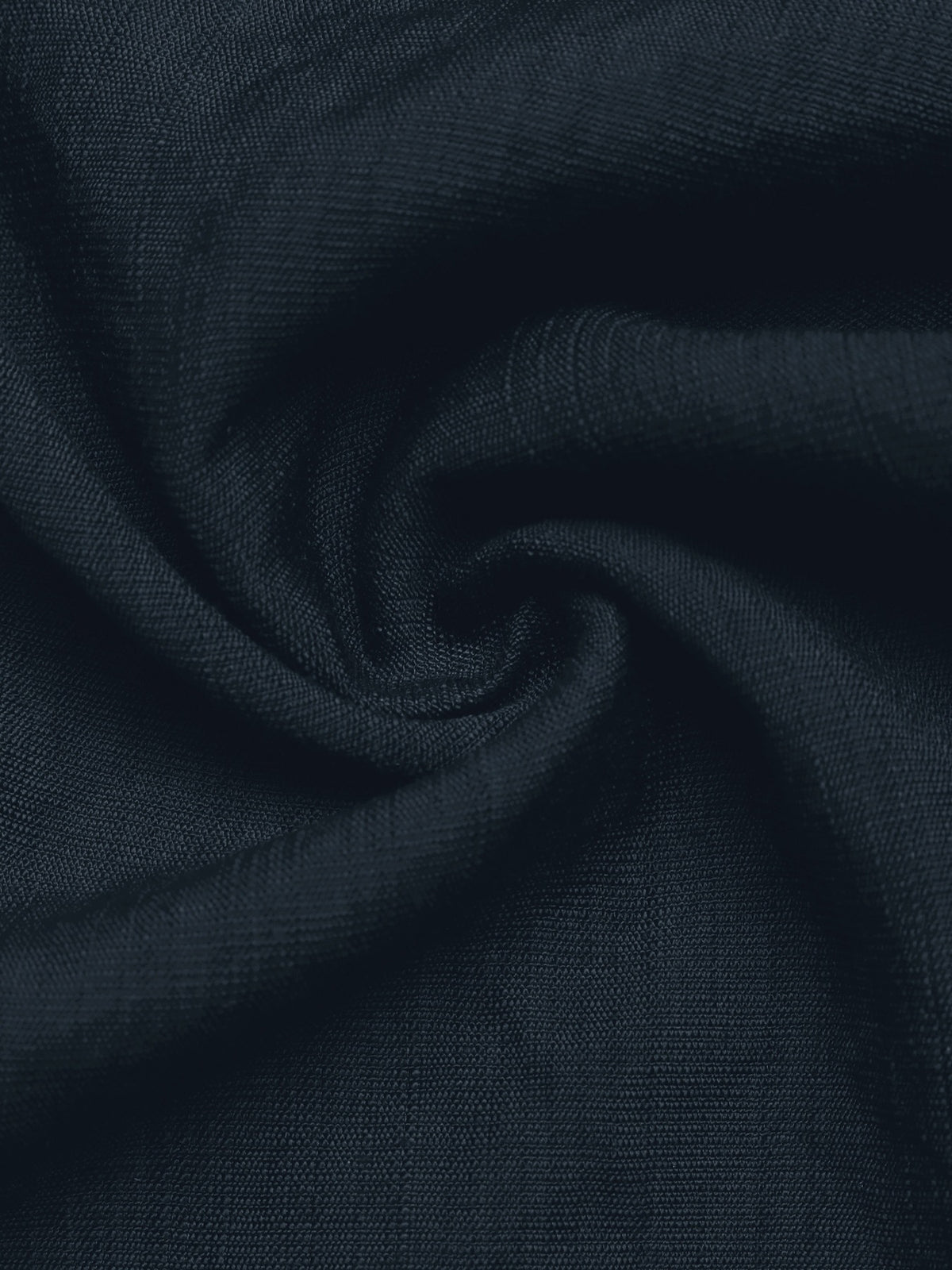 A close-up of dark navy blue textured fabric, swirled in the center to show its woven texture and soft drape.