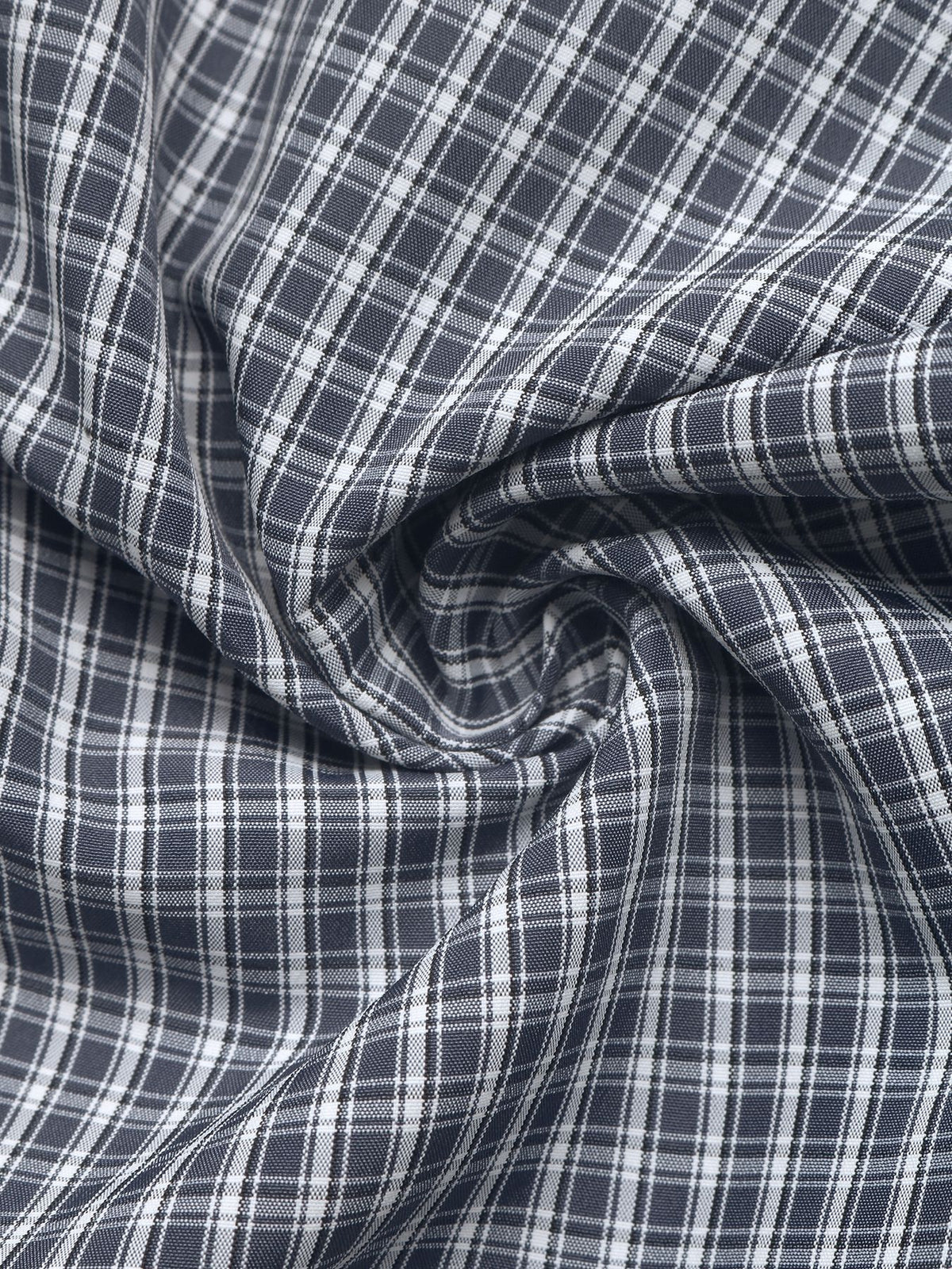 A close-up of draped fabric with a dark gray and white plaid pattern.