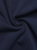 A close-up of dark navy blue fabric with soft folds and a smooth woven texture.
