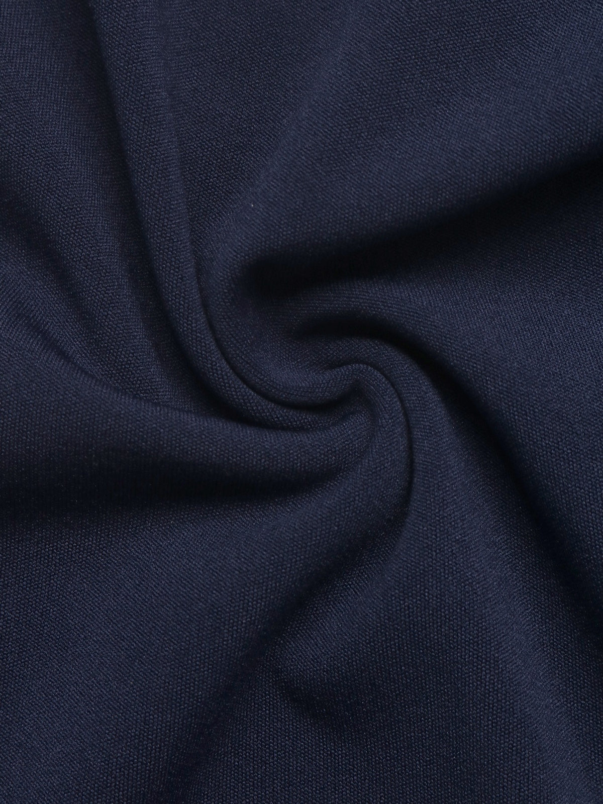 A close-up of dark navy blue fabric with soft folds and a smooth woven texture.
