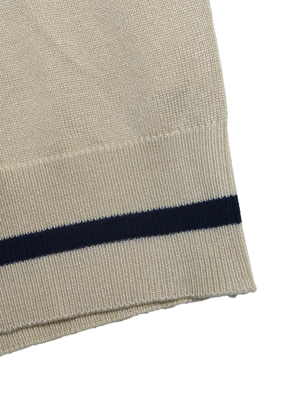 Close-up of a ribbed knit fabric cuff in warm off-white with a single horizontal dark navy stripe near the bottom.