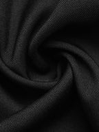 A close-up of black textured fabric with a fine ribbed or woven surface, arranged in soft folds and swirls.