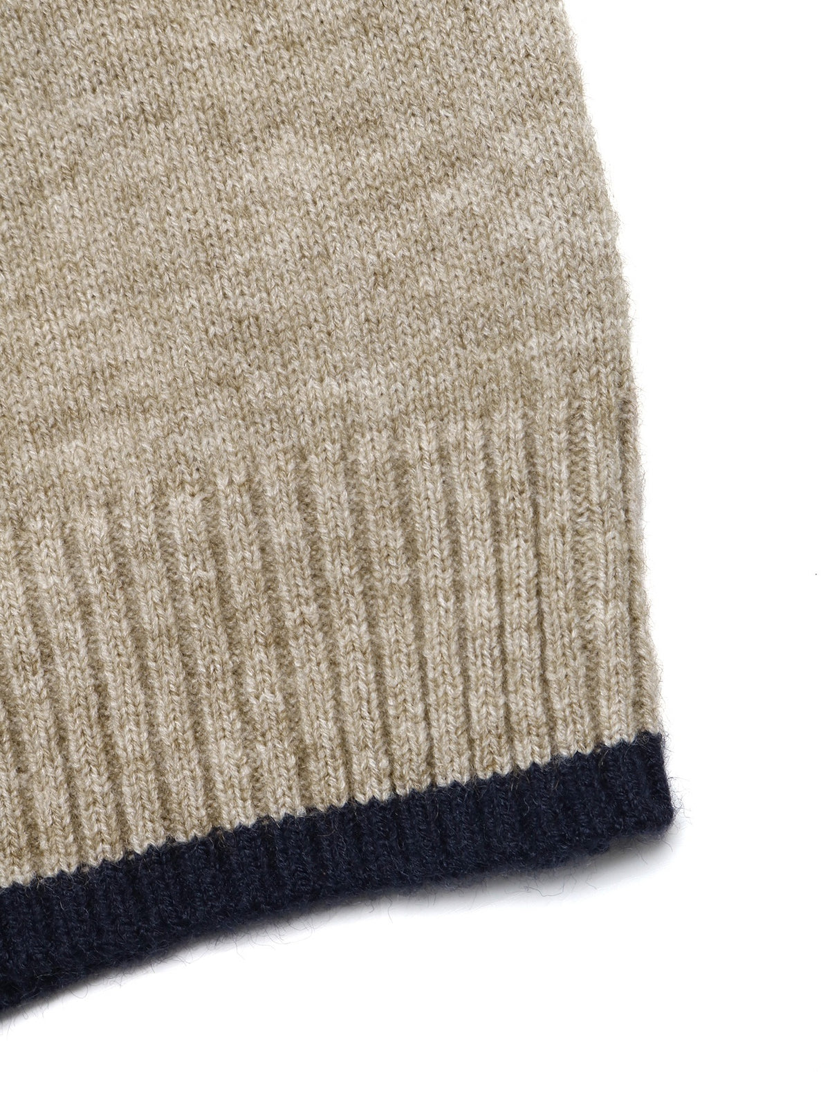 Close-up of a ribbed knit garment corner showing a heathered beige body with a dark navy ribbed cuff on a white background.
