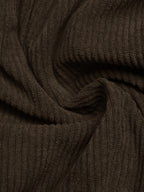 A close-up of dark brown ribbed knit fabric with a soft, draped texture.