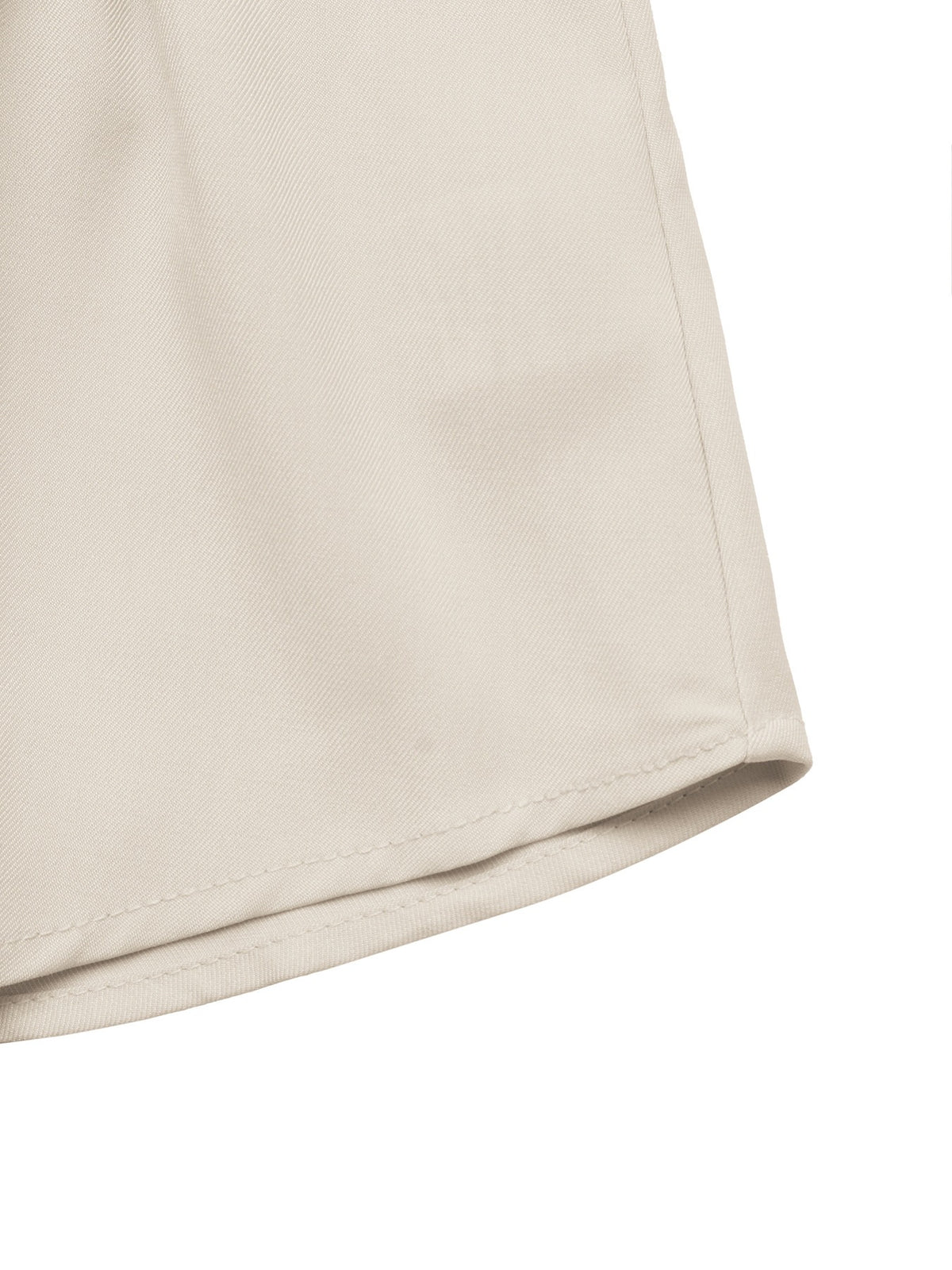 Close-up of a light beige fabric product corner with a visible stitched hem on a white background.