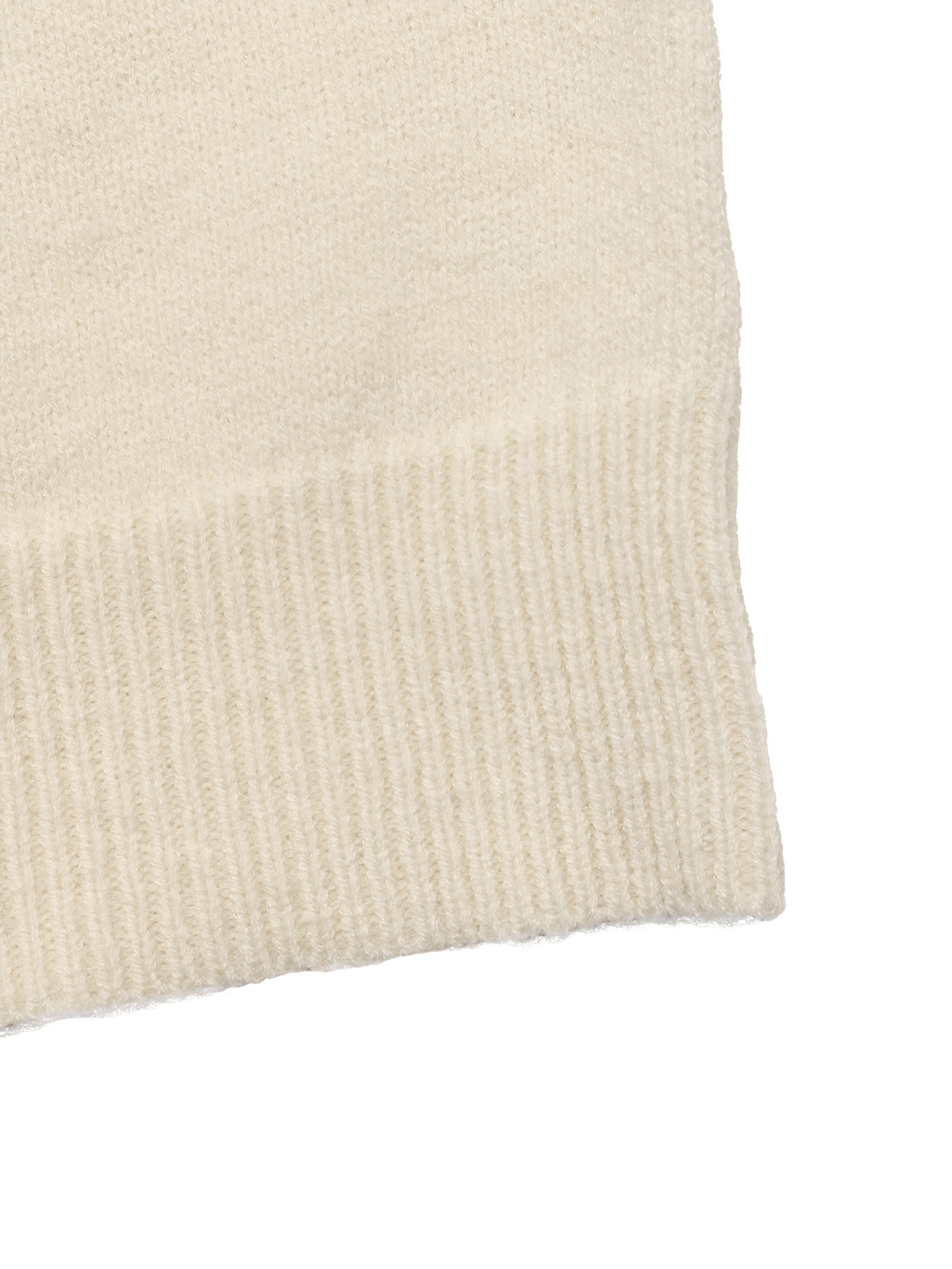 Close-up of a cream-colored knit fabric with a ribbed cuff, showing the texture and color against a white background.