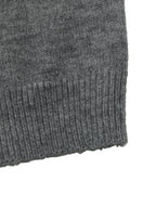 Close-up of a dark gray ribbed knit fabric cuff on a white background.